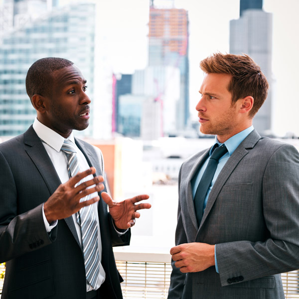 two men in suits talking